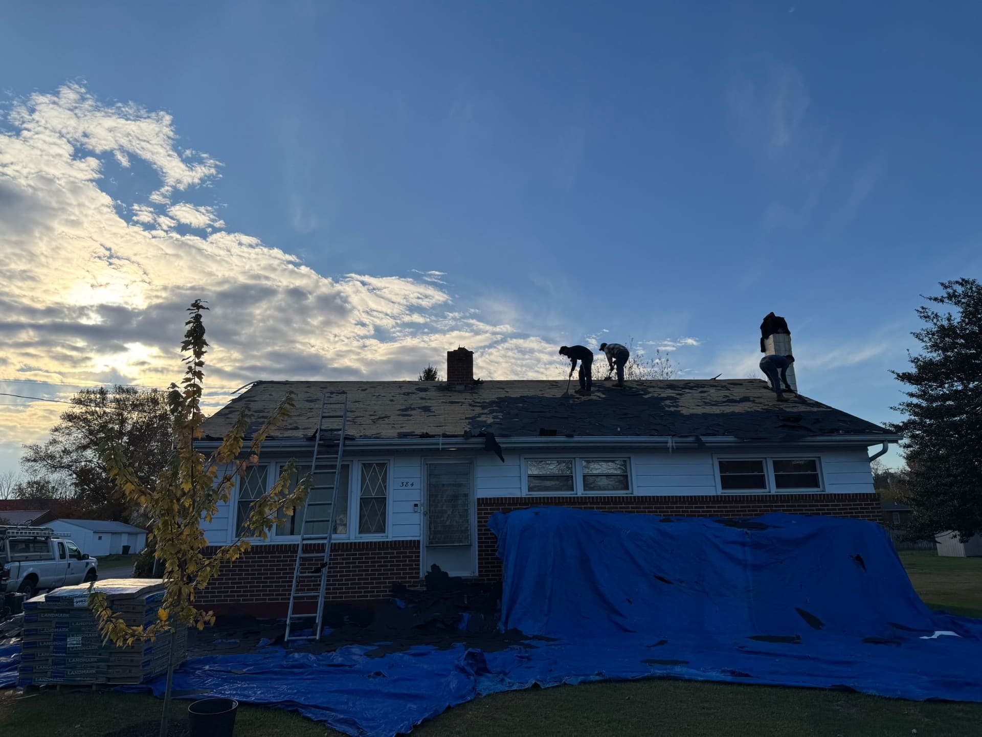 Professional roofing contractors at work on a residential roof